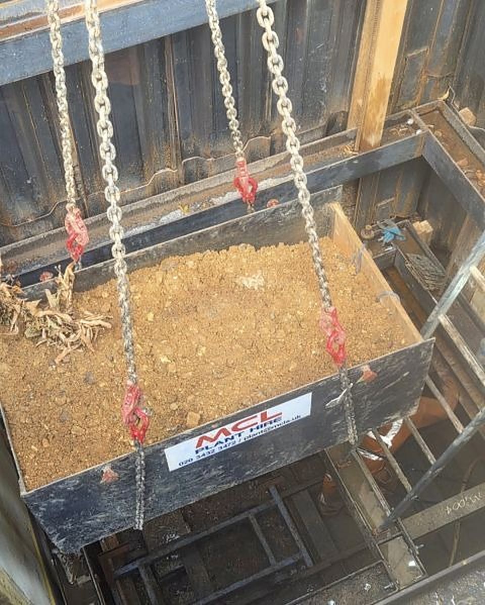 Skip of spoil lifted out of a shaft on chains